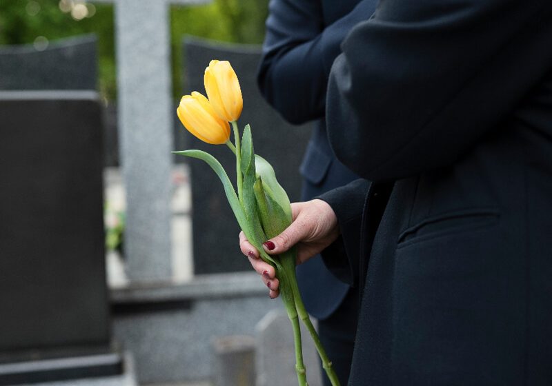 Tulips being brought to a grave at the cemetery